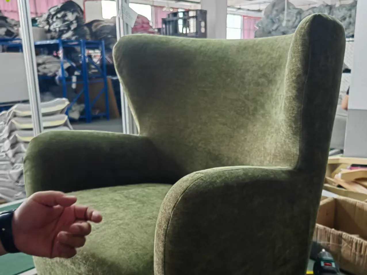 Upholstered wingback chair sample being reviewed in the sample workshop