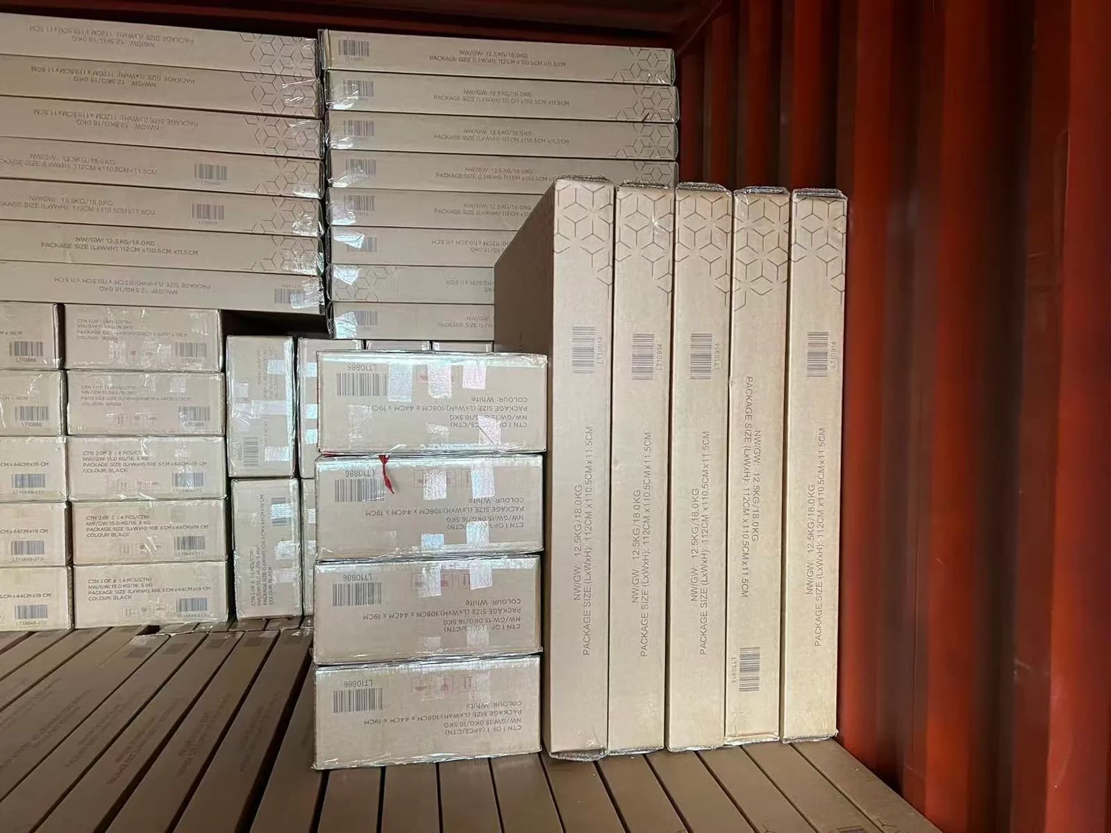 Labelled cartons stacked inside a shipping container