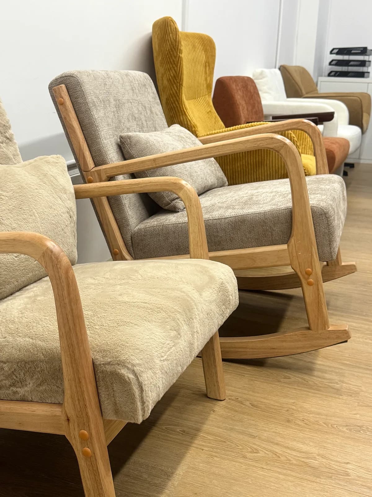 Wooden-frame rocking chairs and lounge armchairs on display at the CasaViva studio