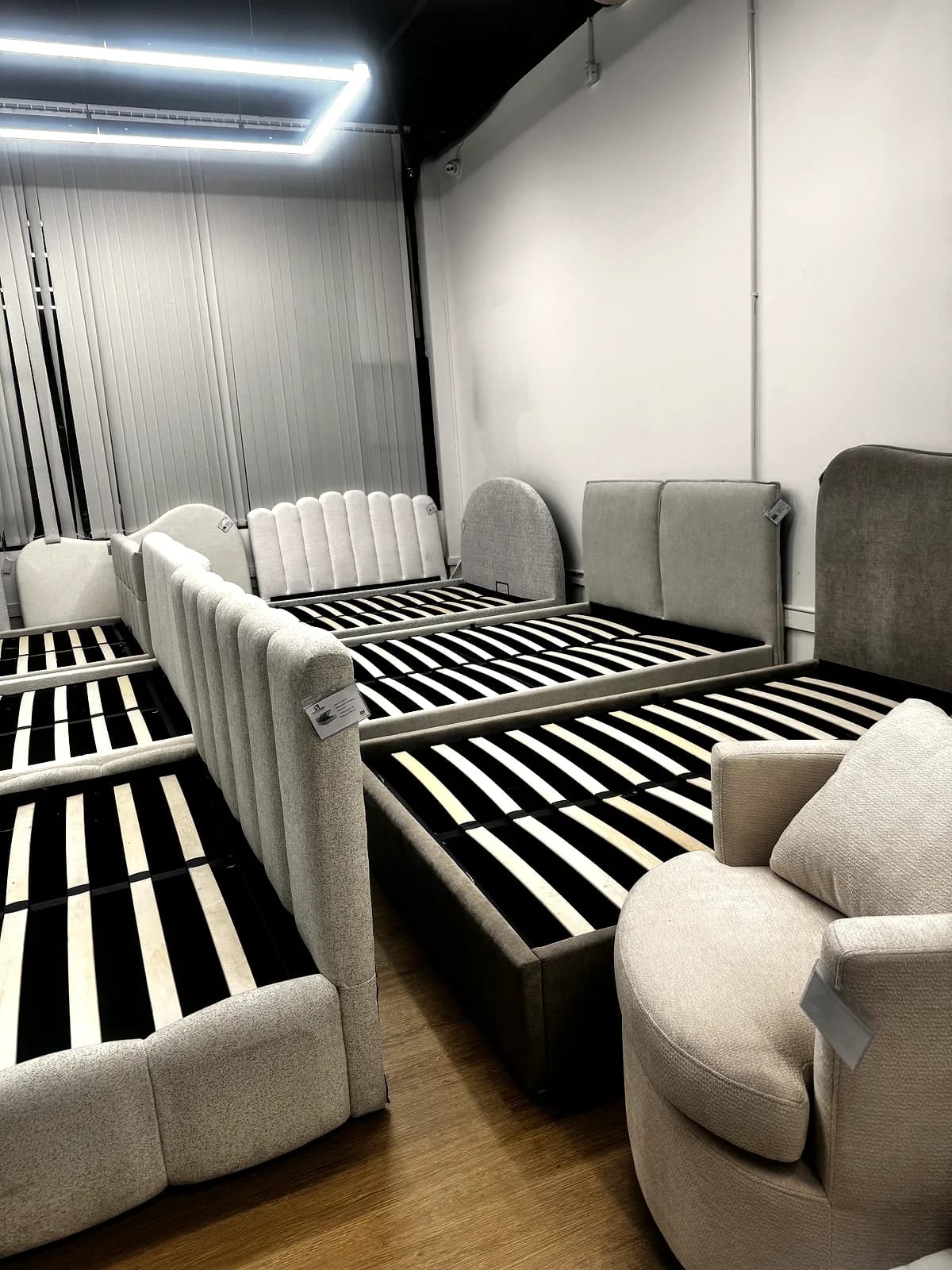 Upholstered bed frames and an upholstered armchair displayed in the CasaViva studio